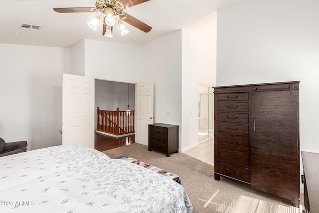 bedroom with light colored carpet, visible vents, and ceiling fan