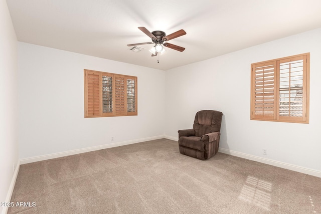 unfurnished room featuring visible vents, carpet floors, baseboards, and a ceiling fan