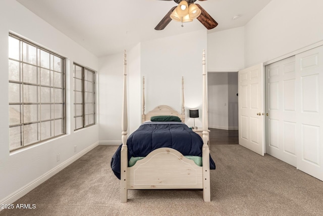 bedroom featuring a closet, ceiling fan, baseboards, and carpet