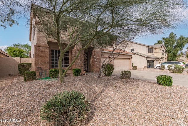 traditional home featuring brick siding, stucco siding, concrete driveway, and a garage