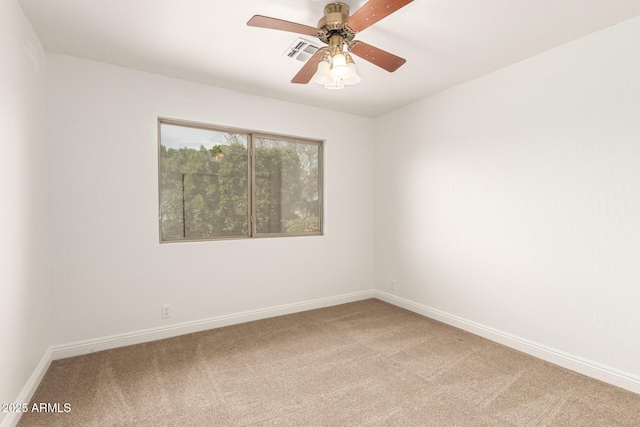 empty room featuring baseboards, light colored carpet, and a ceiling fan