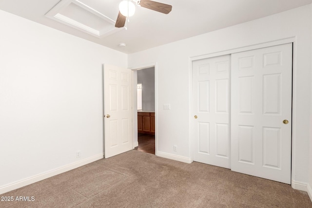 unfurnished bedroom featuring a closet, a ceiling fan, baseboards, and carpet floors