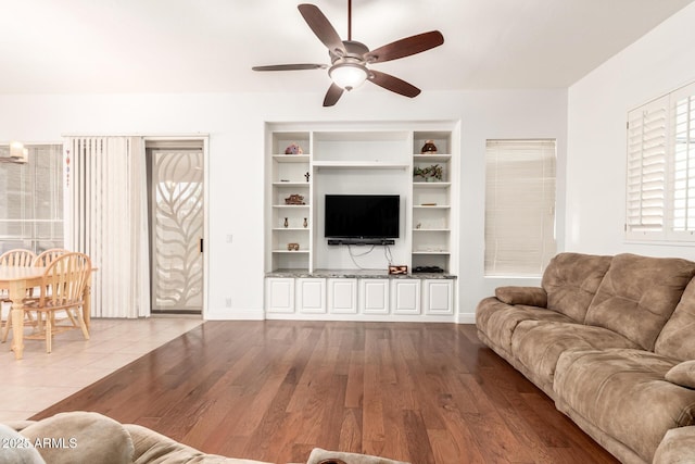 living room with wood finished floors and ceiling fan