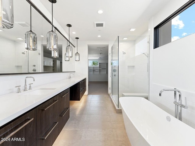 bathroom with vanity, a healthy amount of sunlight, and plus walk in shower