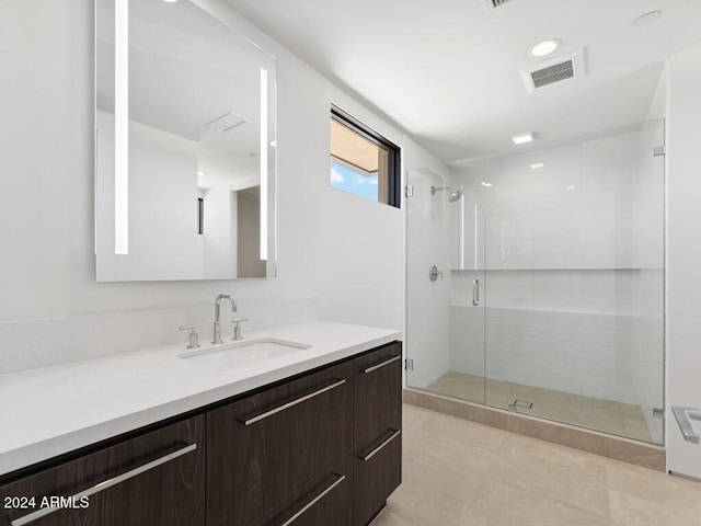 bathroom featuring tile patterned floors, vanity, and walk in shower