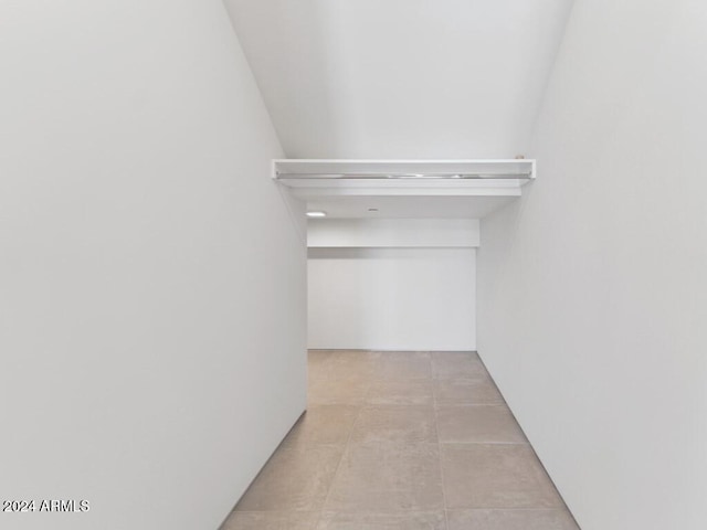 spacious closet with light tile patterned floors