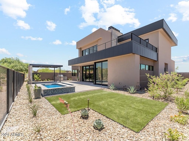 back of house with a lawn, a balcony, and a patio