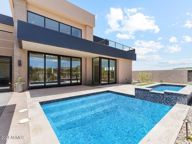 view of pool with a patio area and an in ground hot tub