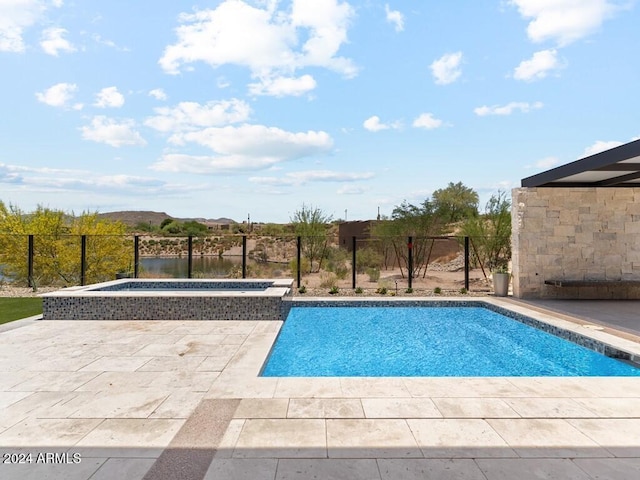 view of swimming pool with an in ground hot tub