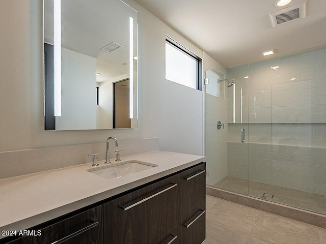 bathroom with tile patterned flooring, vanity, and an enclosed shower