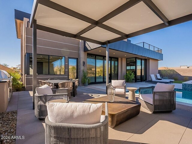 view of patio / terrace with an outdoor living space and a balcony