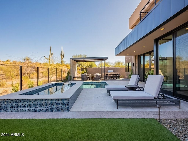 view of pool featuring a patio and a hot tub