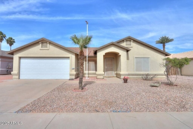 ranch-style house with concrete driveway, an attached garage, and stucco siding