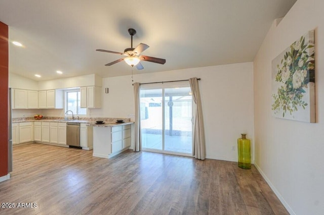 kitchen featuring dishwasher, light wood-type flooring, plenty of natural light, and white cabinets