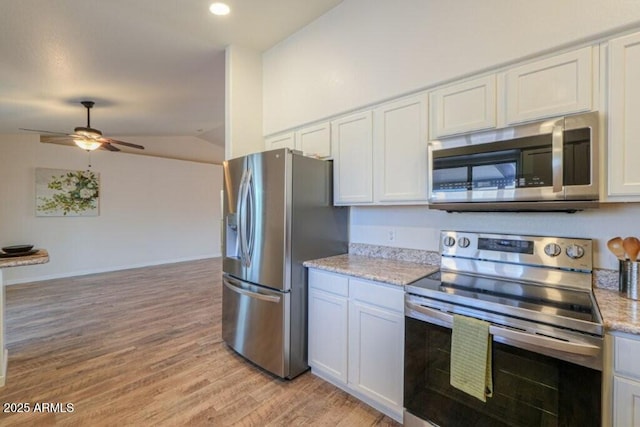 kitchen with light stone counters, light wood finished floors, appliances with stainless steel finishes, a ceiling fan, and vaulted ceiling