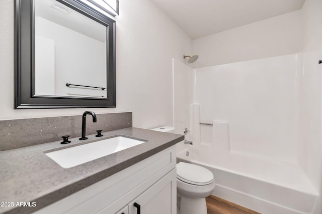 full bathroom featuring visible vents, toilet, shower / tub combination, wood finished floors, and vanity