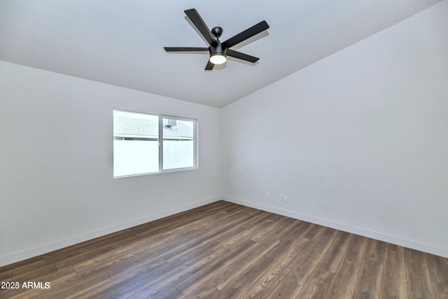 unfurnished room featuring dark wood-style floors, lofted ceiling, baseboards, and a ceiling fan