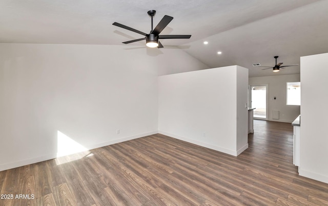 spare room with lofted ceiling, baseboards, and dark wood finished floors