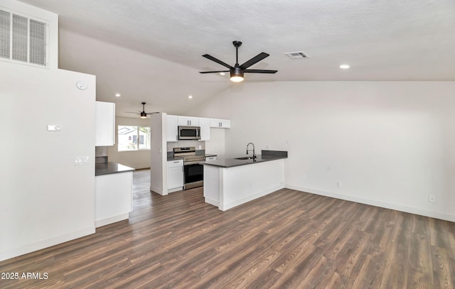 kitchen with stainless steel appliances, visible vents, white cabinetry, and a peninsula