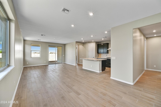 unfurnished living room featuring light wood-type flooring