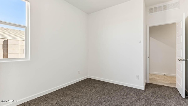 11891 E Cliffrose Ln, Florence, AZ 85132 - empty room featuring dark colored carpet