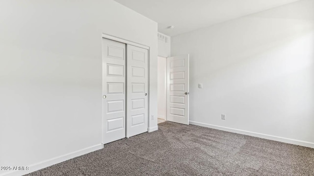 11891 E Cliffrose Ln, Florence, AZ 85132 - unfurnished bedroom featuring dark carpet and a closet