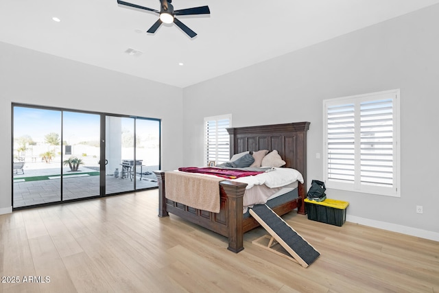 bedroom featuring access to exterior, visible vents, light wood-style floors, ceiling fan, and baseboards