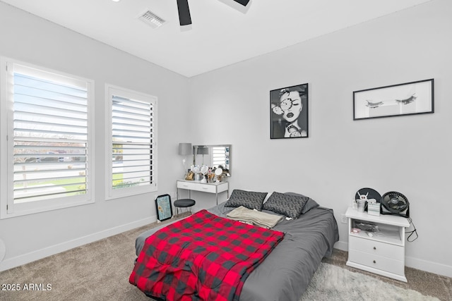 bedroom with a ceiling fan, light colored carpet, visible vents, and baseboards