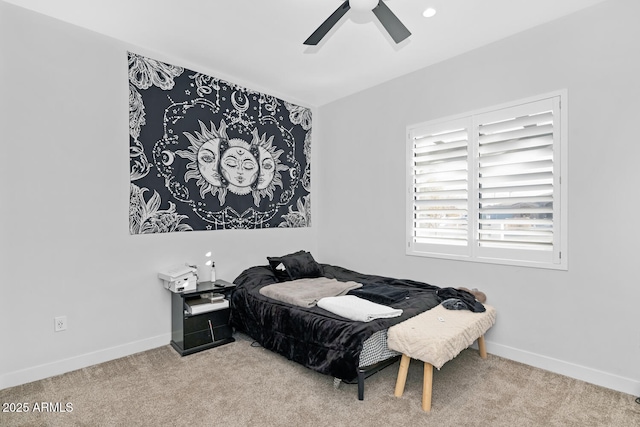 bedroom with light carpet, baseboards, and a ceiling fan