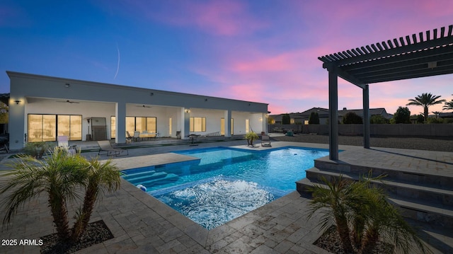 pool at dusk featuring a patio area, ceiling fan, a pergola, and a fenced in pool