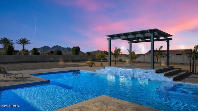 pool at dusk featuring a fenced in pool, a patio area, a fenced backyard, and a pergola