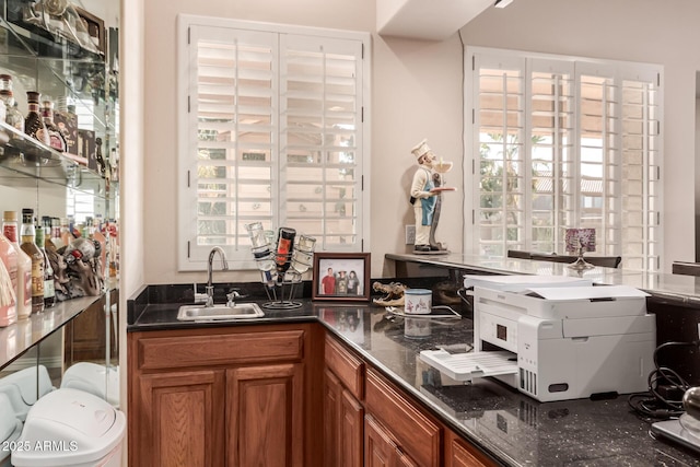 kitchen with sink and dark stone countertops