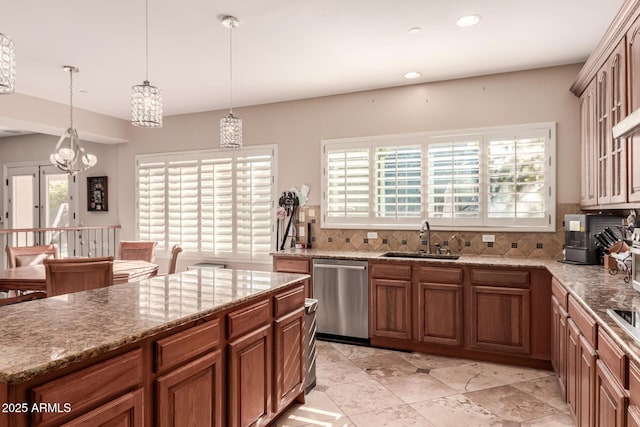 kitchen featuring dishwasher, decorative light fixtures, a notable chandelier, backsplash, and sink