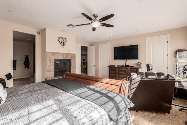 bedroom featuring ceiling fan, a fireplace, and carpet flooring