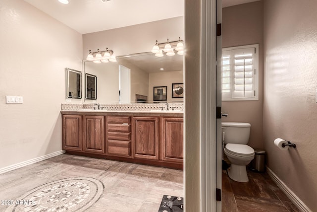 bathroom featuring toilet and vanity