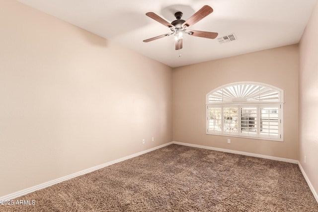 carpeted spare room featuring ceiling fan