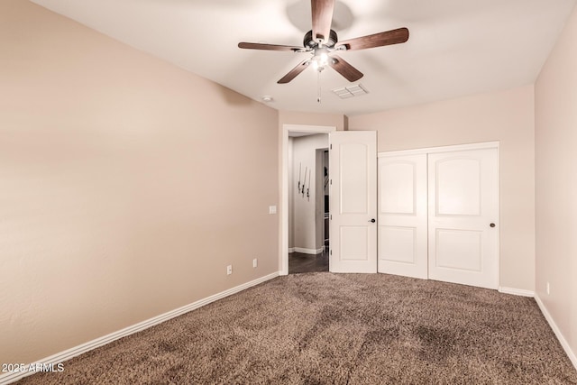 unfurnished bedroom featuring a closet, ceiling fan, and dark carpet