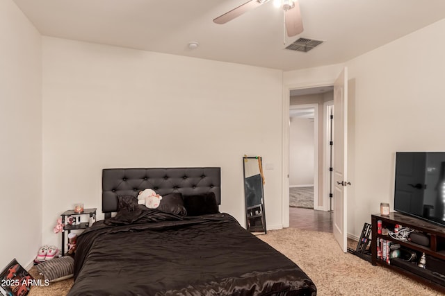 bedroom featuring ceiling fan and light carpet