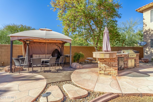 view of patio / terrace with a grill, area for grilling, and a gazebo