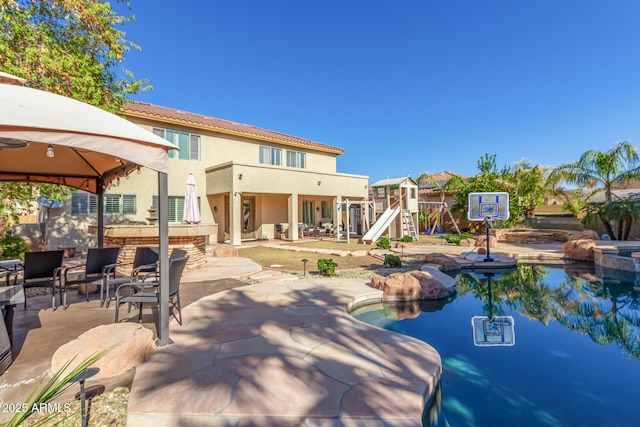 back of property featuring a gazebo, a balcony, and a patio area