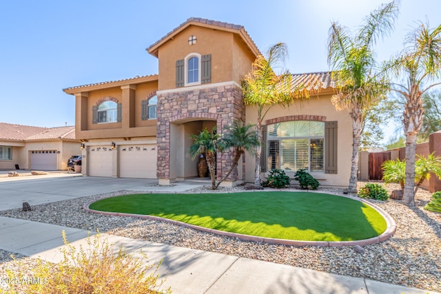 mediterranean / spanish-style house with a front yard and a garage