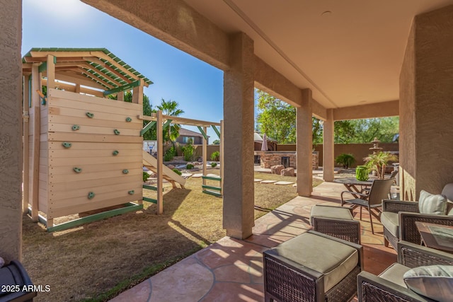 view of patio / terrace with a playground and an outdoor living space