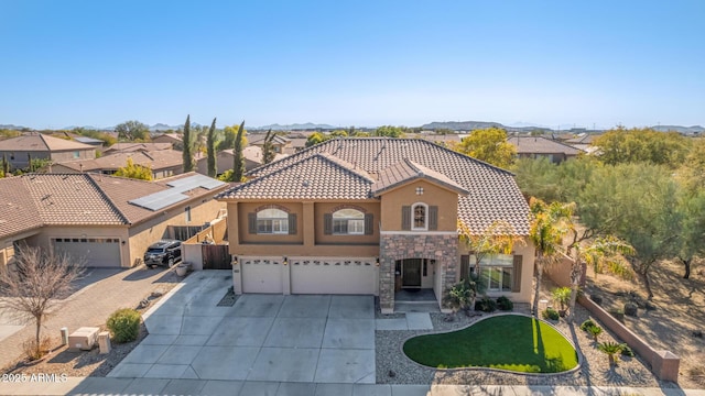 mediterranean / spanish home featuring a garage