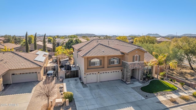 view of front of house featuring a garage and a mountain view