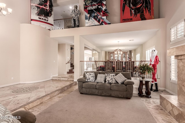 living room featuring a high ceiling and a chandelier