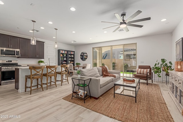 656 S Owl Dr, Gilbert, AZ 85296 - living room with light wood-style floors, recessed lighting, and a ceiling fan