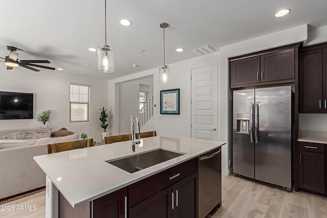 656 S Owl Dr, Gilbert, AZ 85296 - kitchen with stainless steel appliances, a sink, open floor plan, recessed lighting, and light wood finished floors