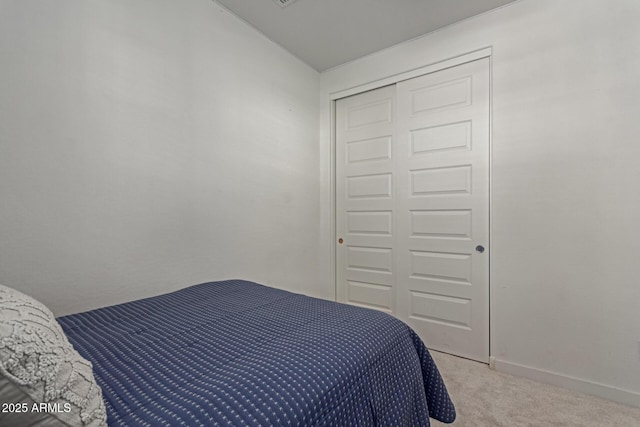 656 S Owl Dr, Gilbert, AZ 85296 - bedroom featuring light colored carpet, a closet, and baseboards