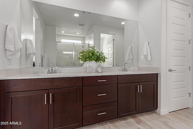656 S Owl Dr, Gilbert, AZ 85296 - full bath featuring a stall shower, double vanity, recessed lighting, and wood finished floors