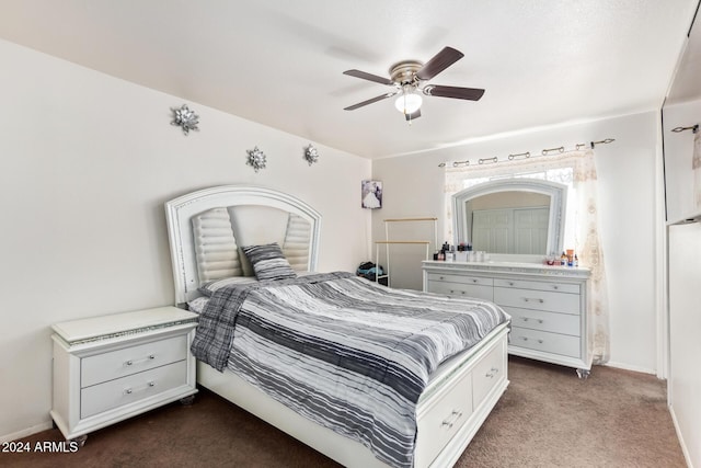 bedroom with ceiling fan and dark carpet